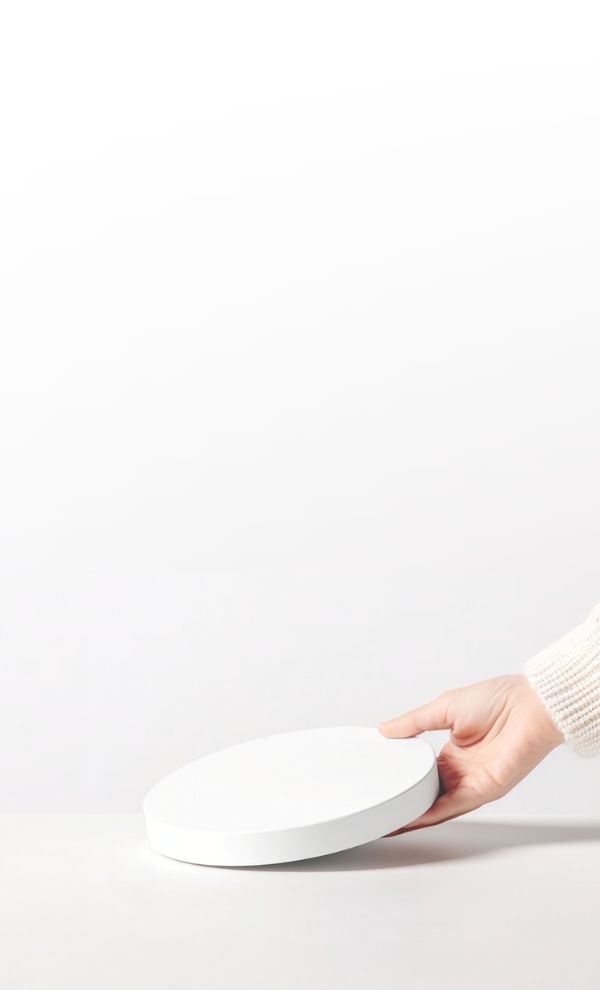 A hand positioning the Apeiron Guard Sculpture Sensor on a display surface