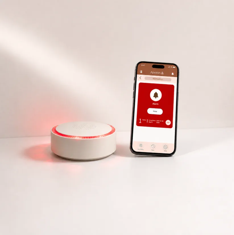 Apeiron Guard Mini Alarm Hub flashing red beside a phone showing an alarm notification