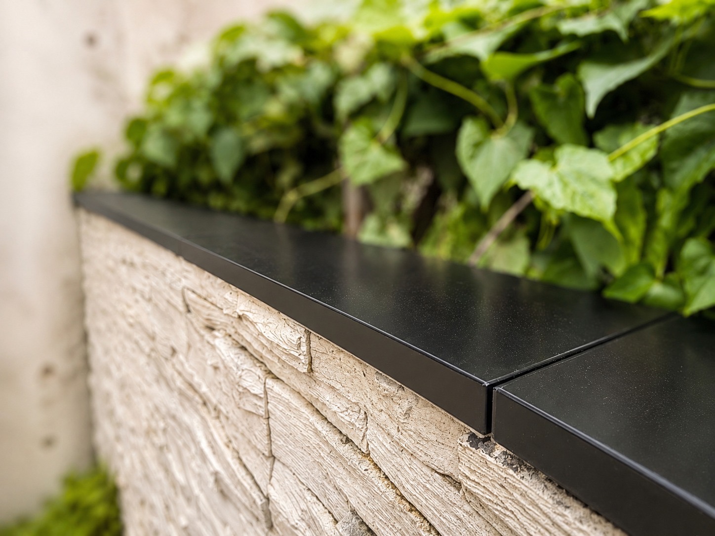 Low-profile Apeiron Guard sensors aligned at the corner of a stone-clad residential wall
